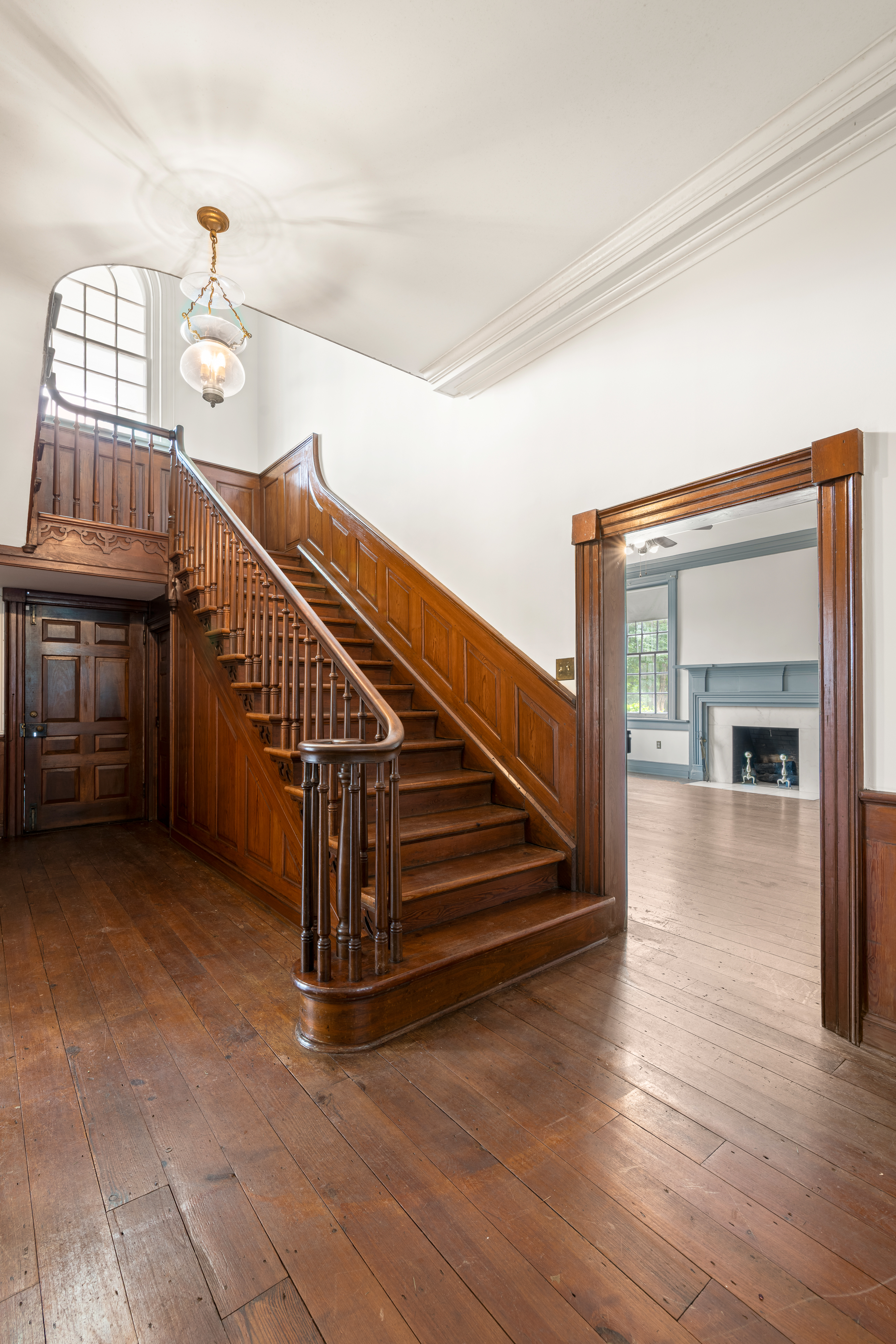 The staircase beneath a hanging chandelier