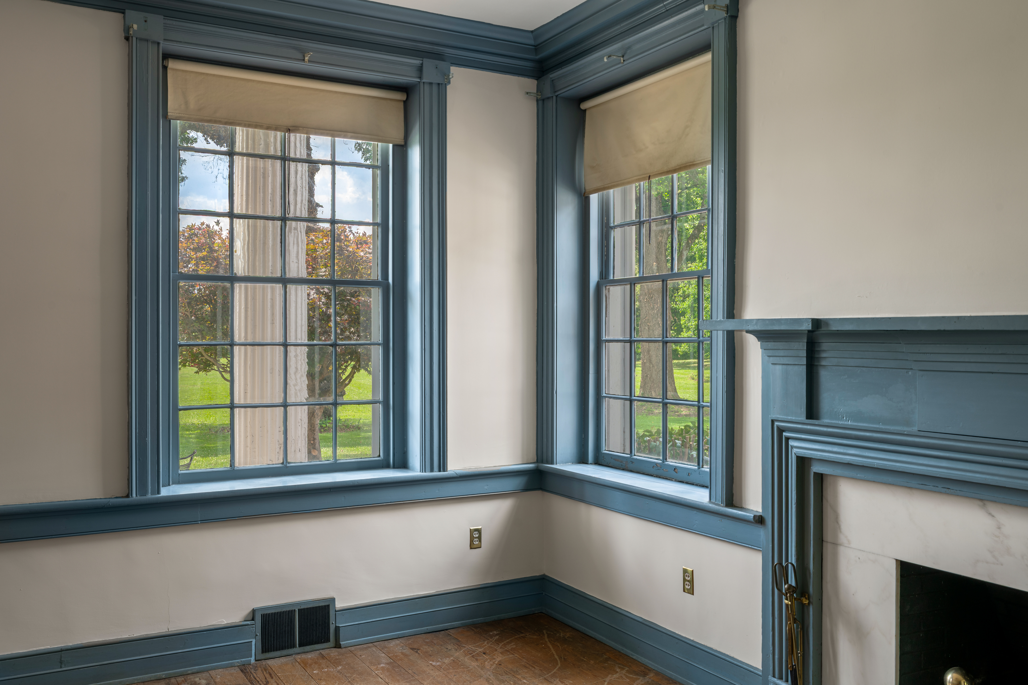 A corner sitting room with delft-tile hearth