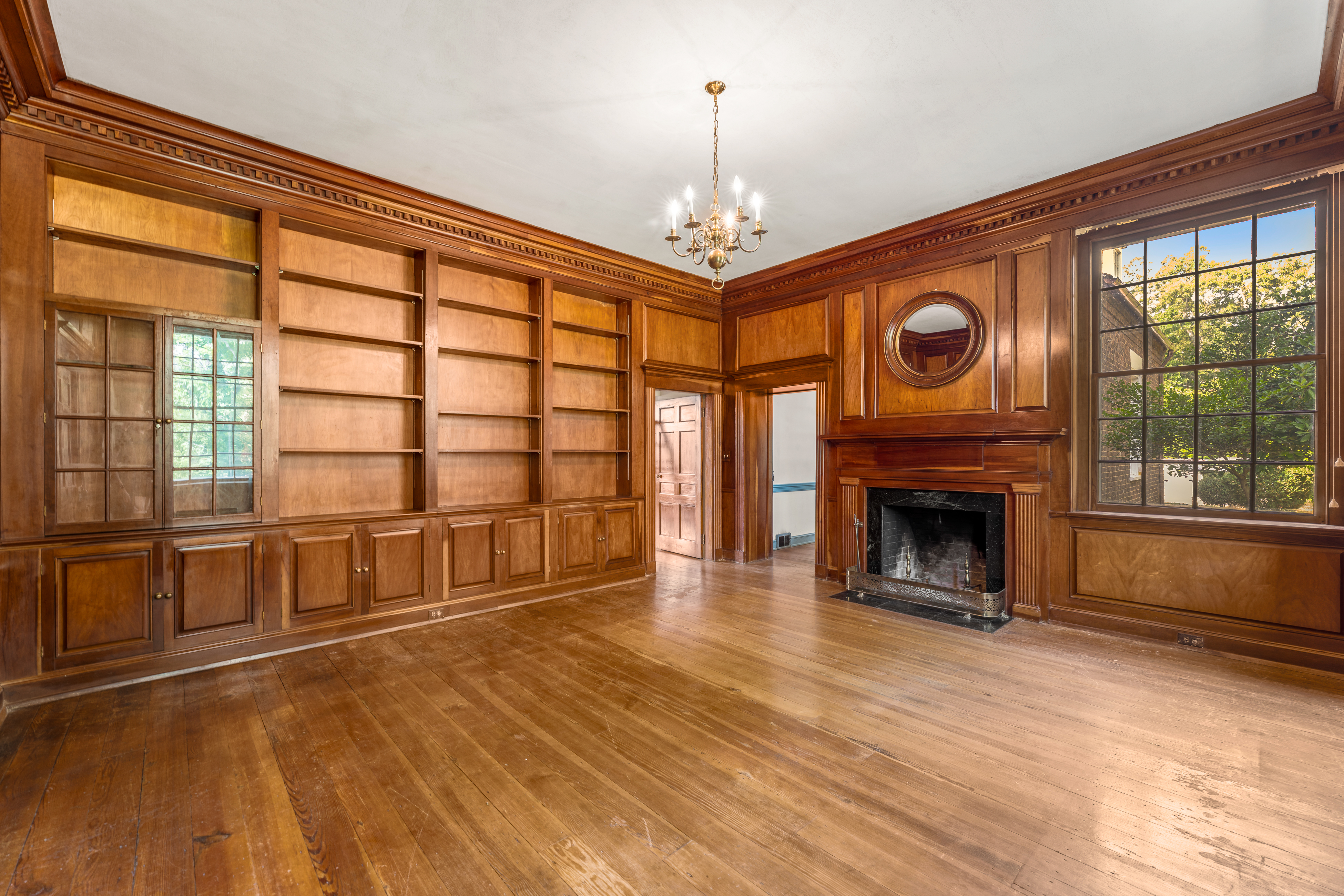 The library — floor-to-ceiling cherry paneling and hearth