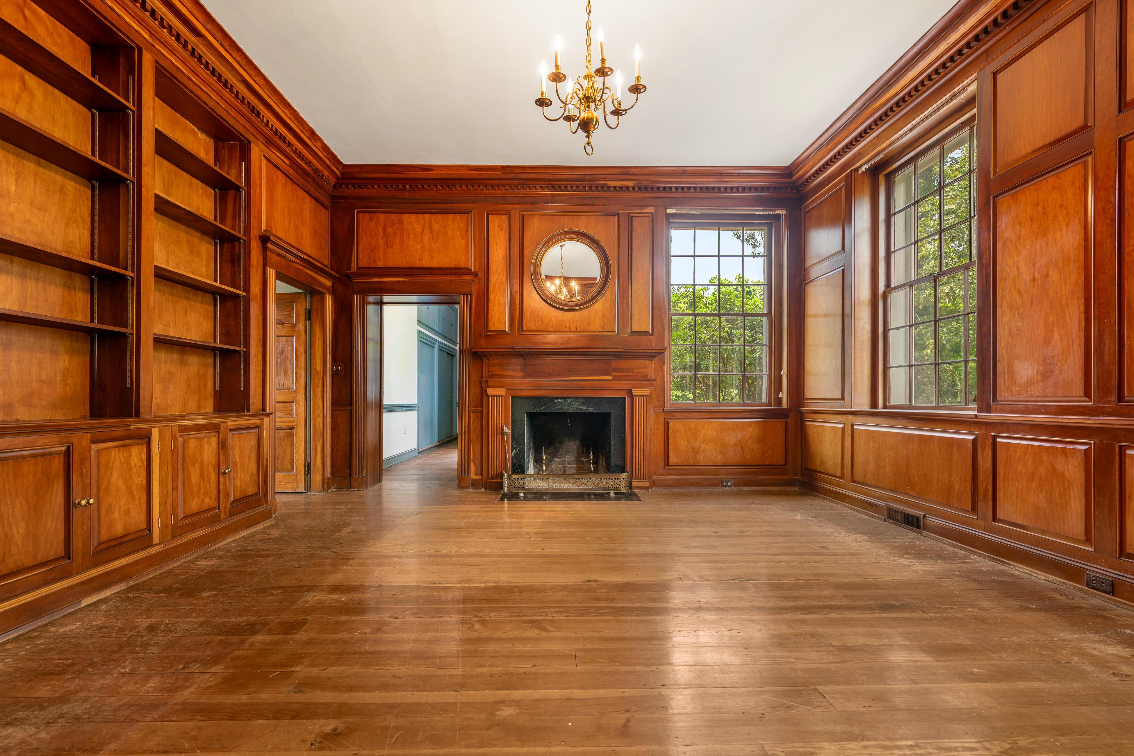 The library — hearth wall and river-view sash