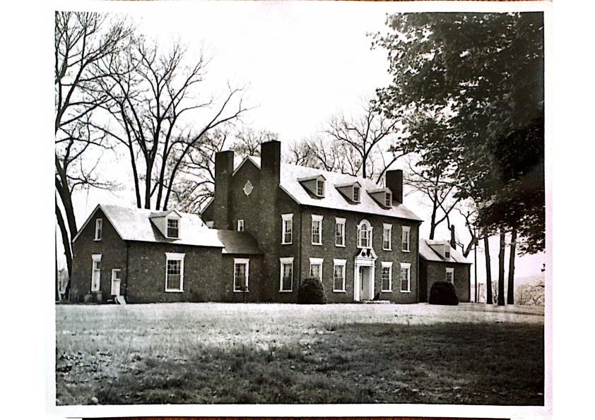 The manor in winter — the full elevation among bare hardwoods