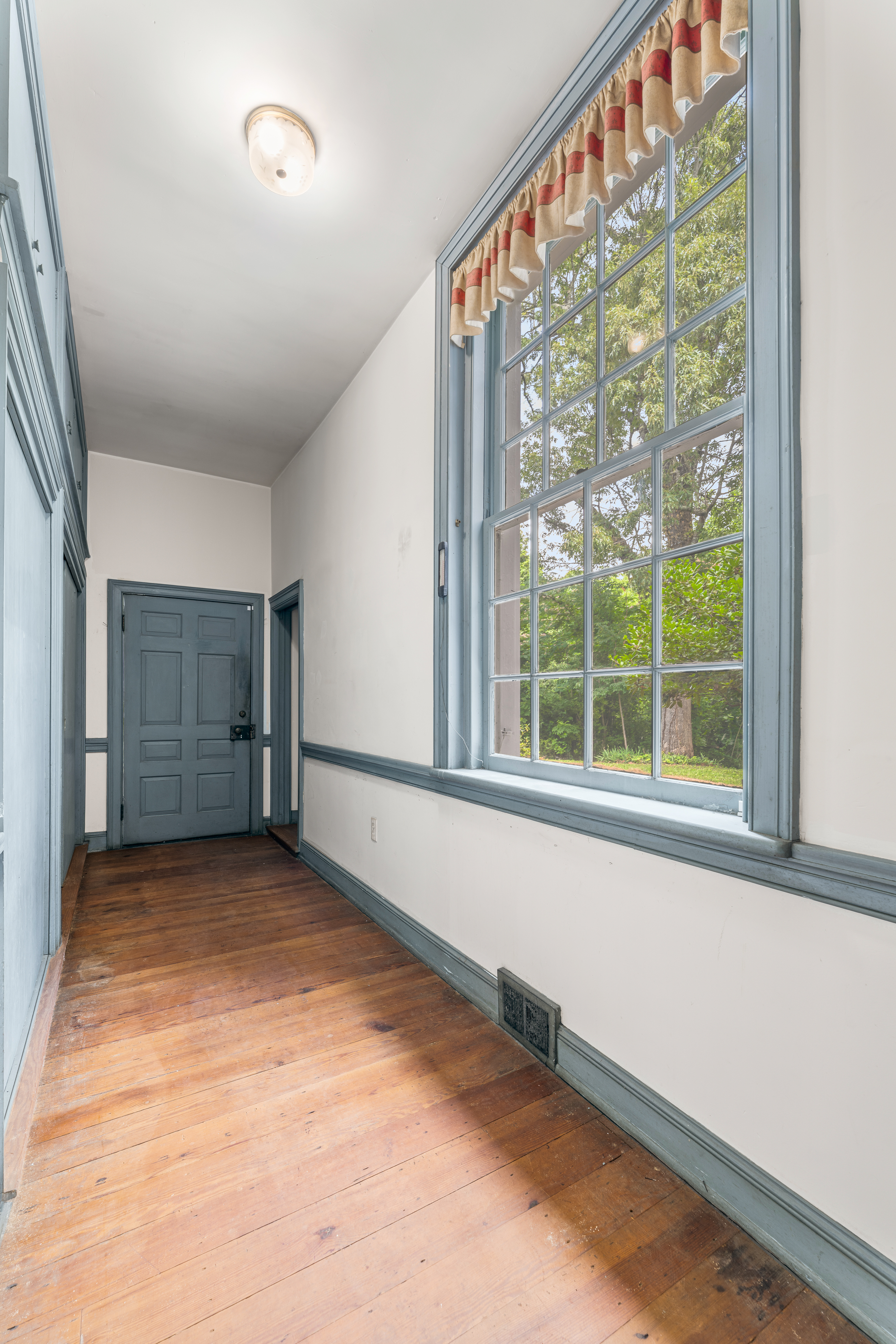 An upper-hall sash window against painted plaster