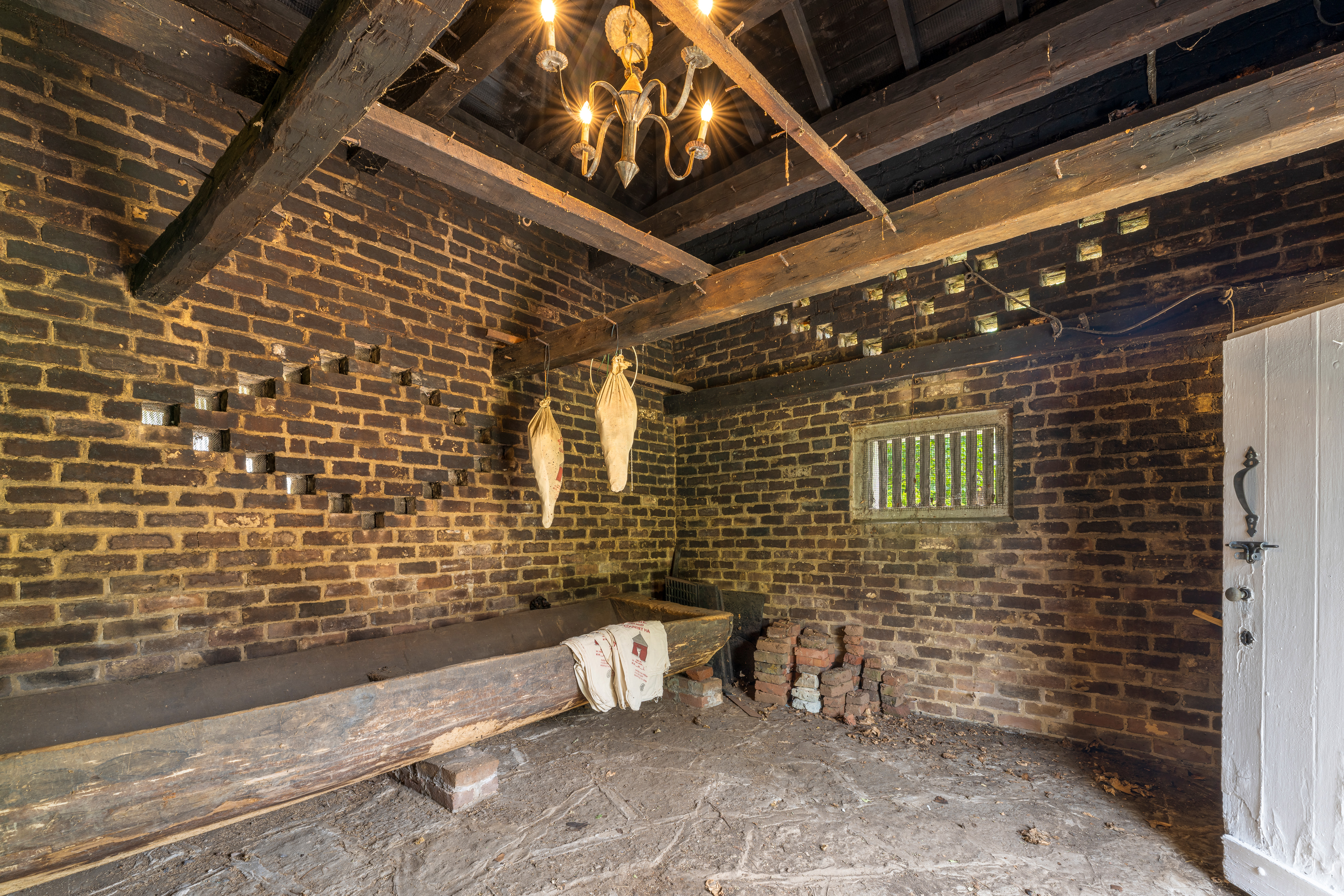 Inside the smoke house — brick walls and curing beams