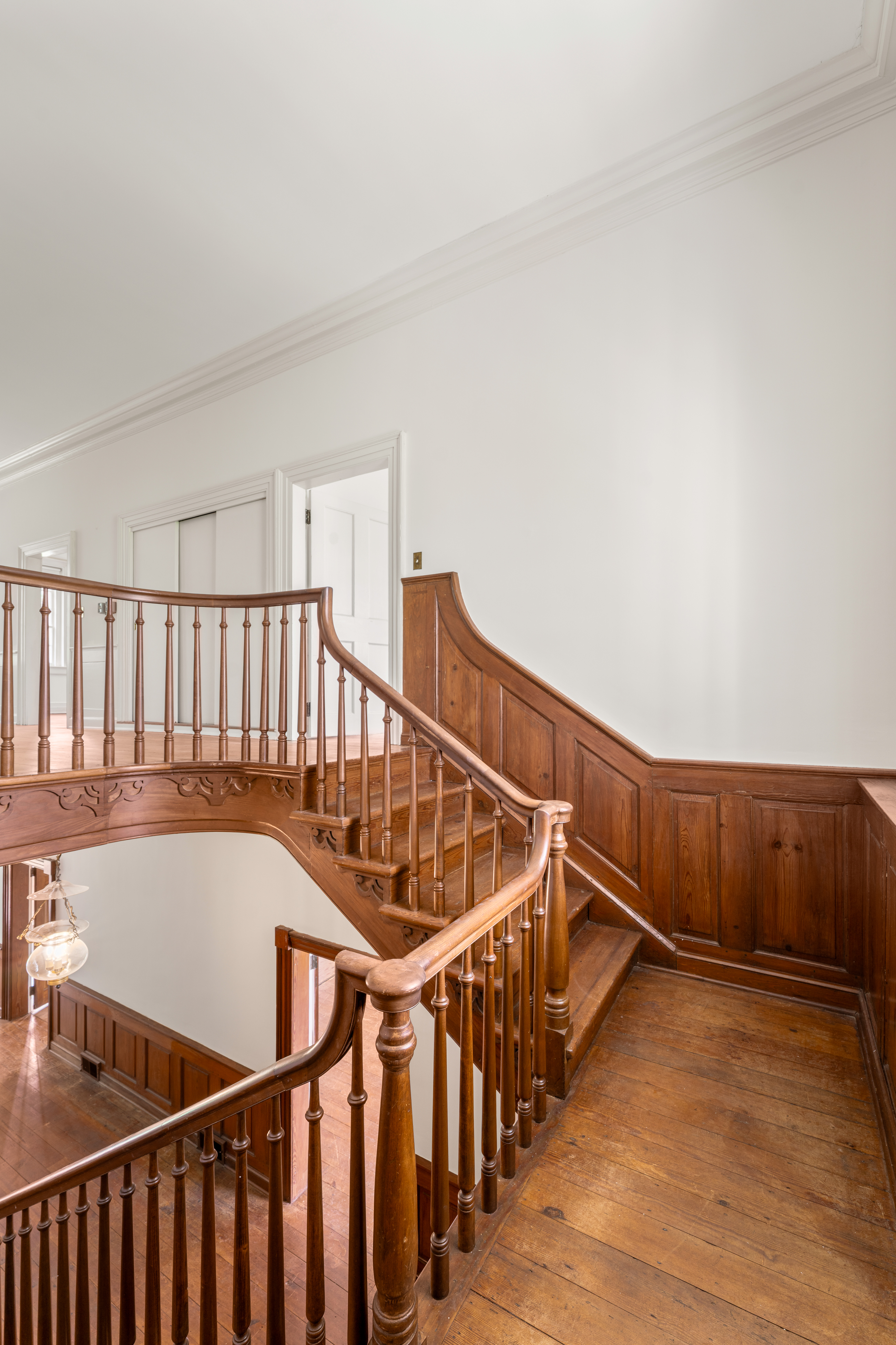 The upper stair — turned mahogany balusters from above