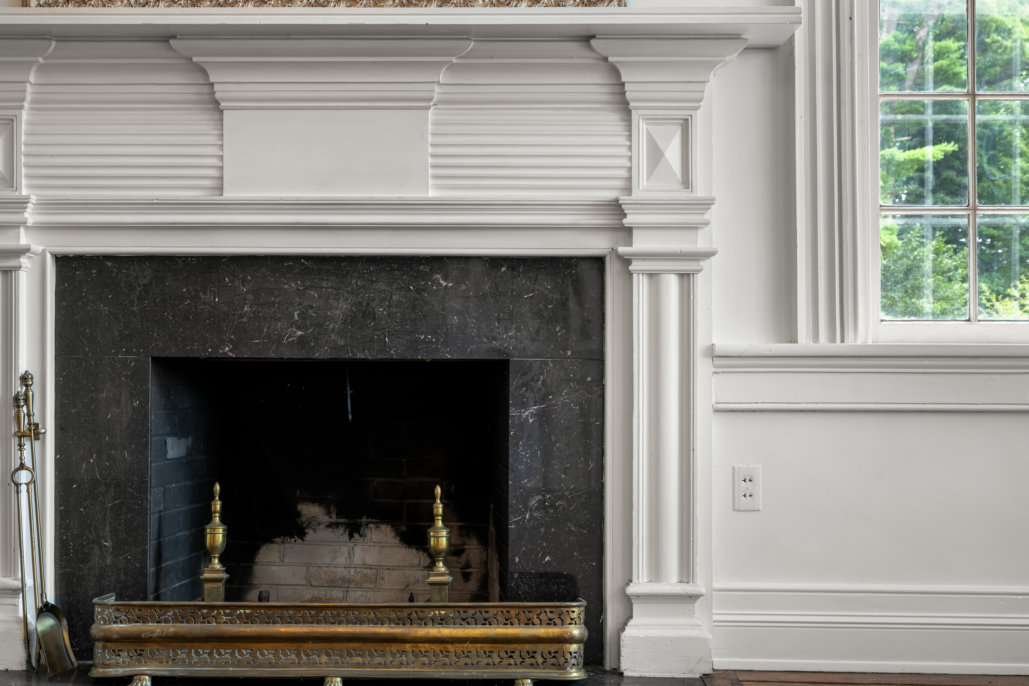 A parlor mantel — fluted pilasters and marble surround