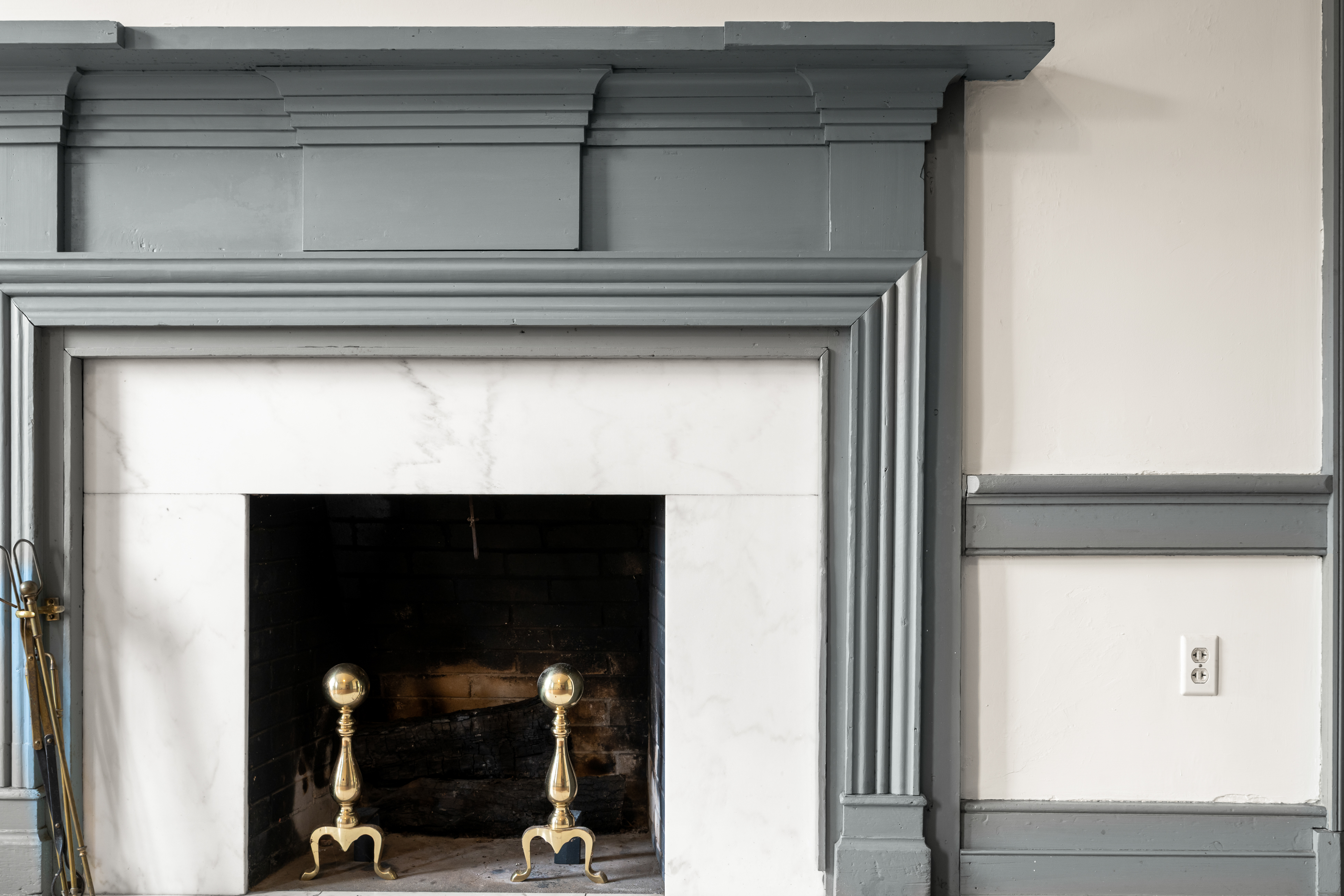A principal bedchamber with carved gray mantel
