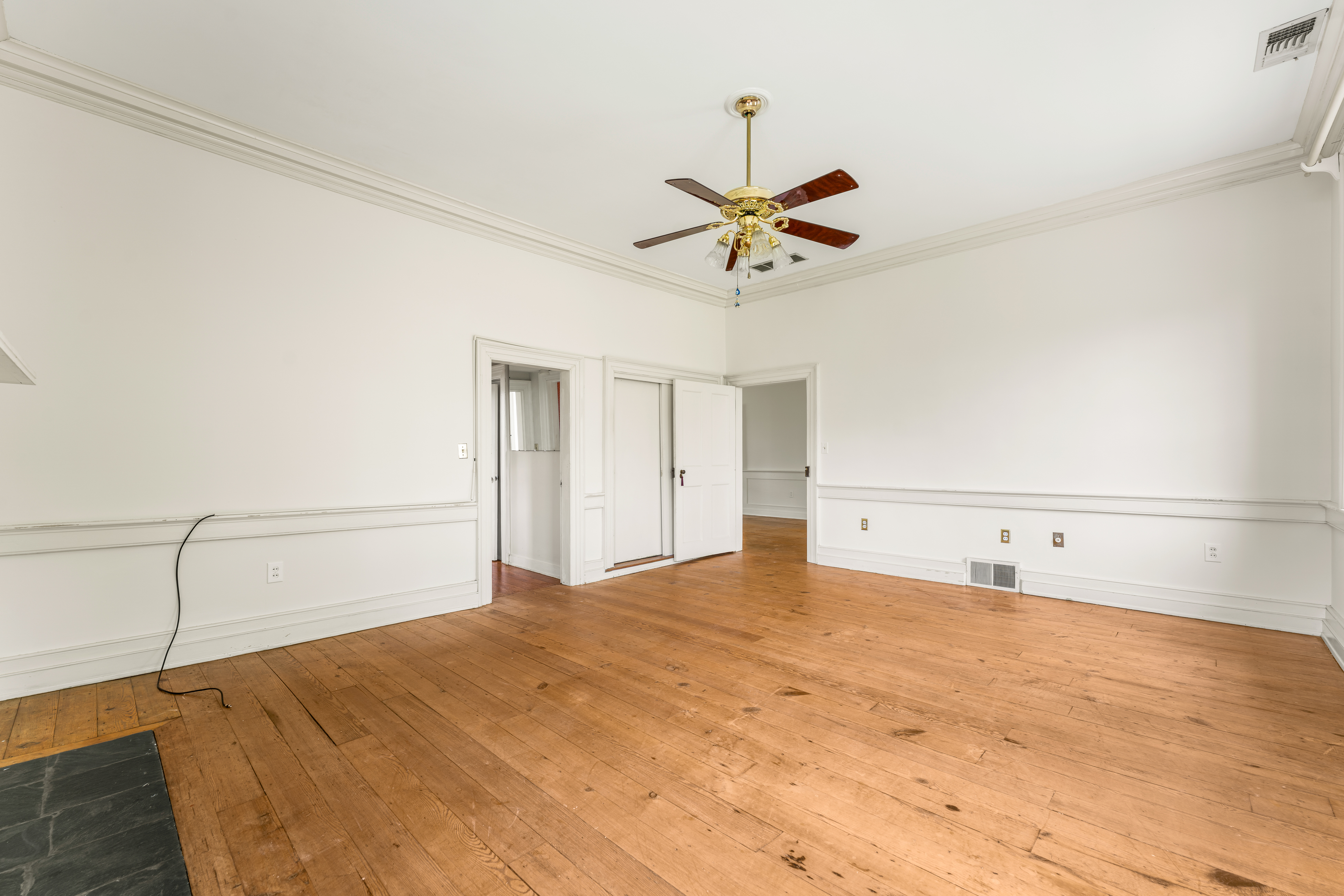 A generous bedchamber with wide-plank floors