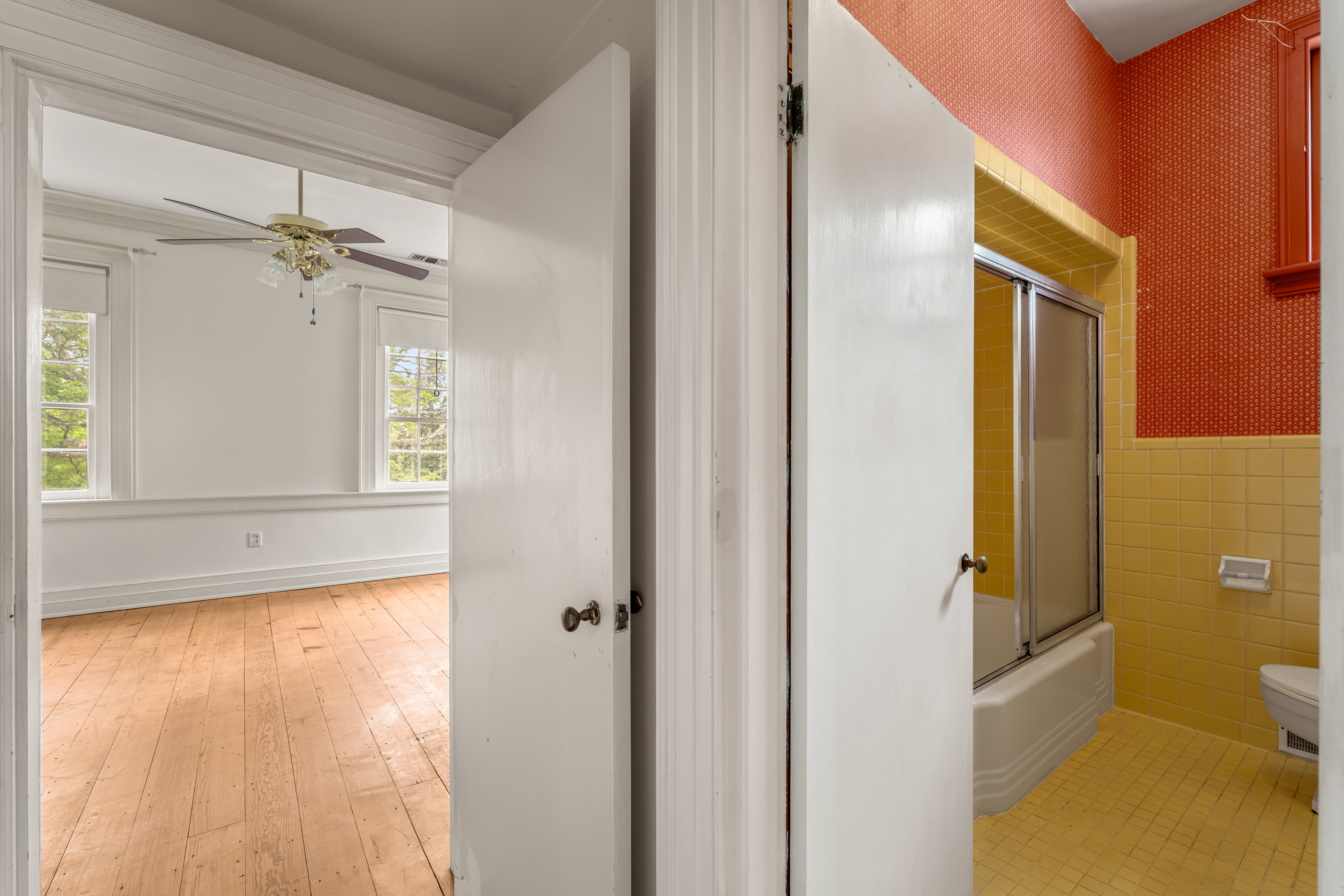 An upper room with corner windows and painted trim