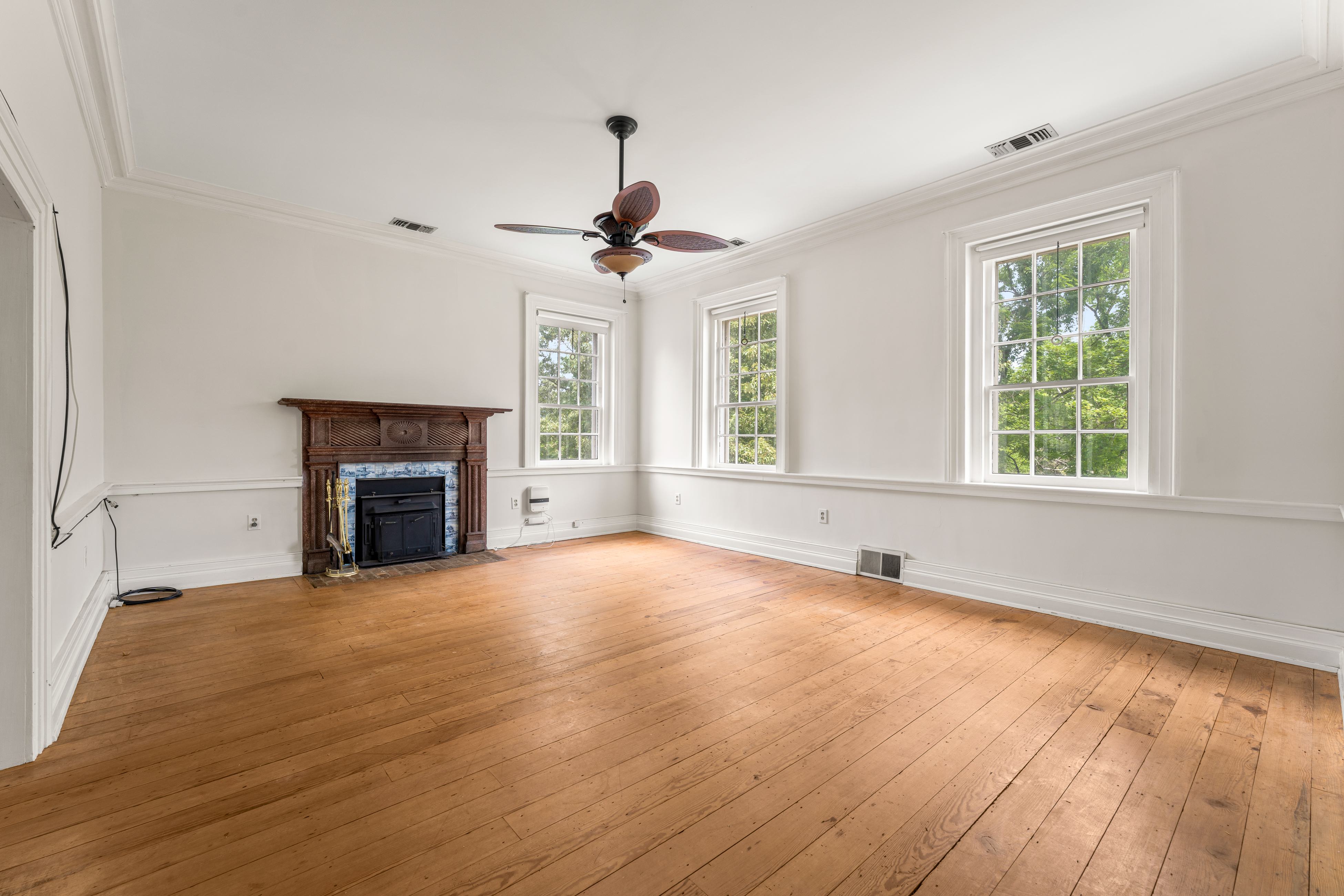 A light-filled bedchamber beneath a ceiling fan