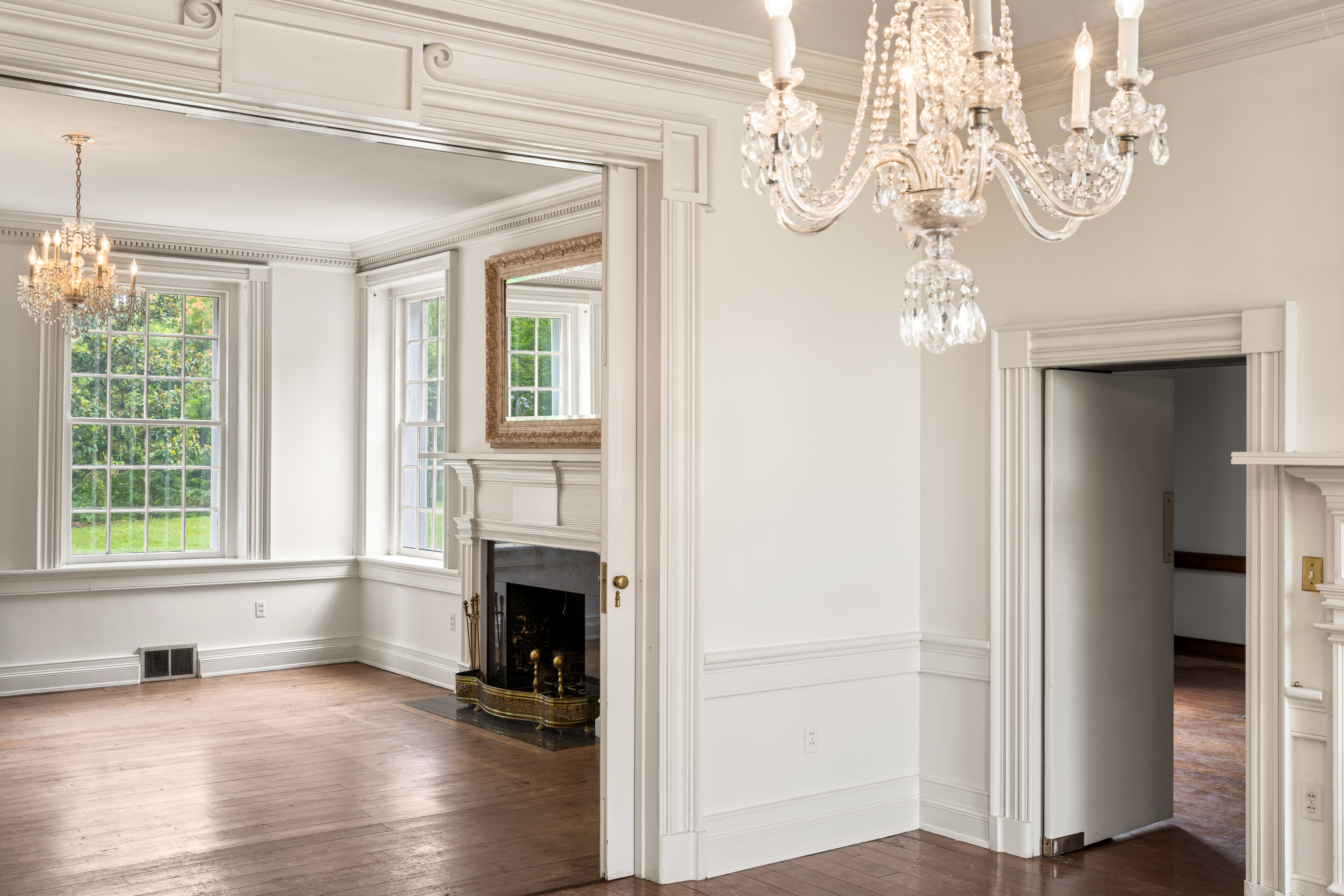 A parlor with carved mantel and marble surround
