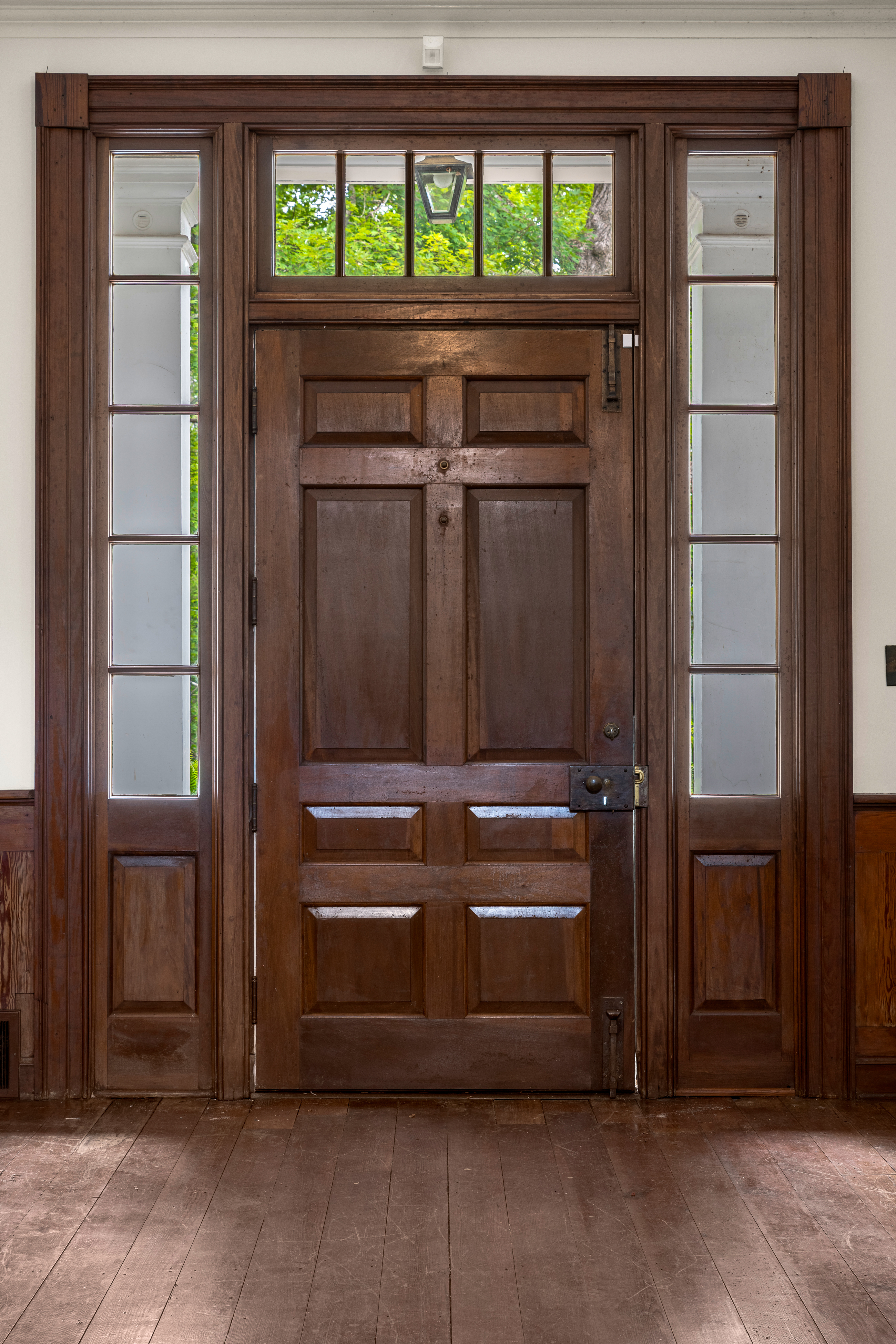 The paneled front-door vestibule with side table