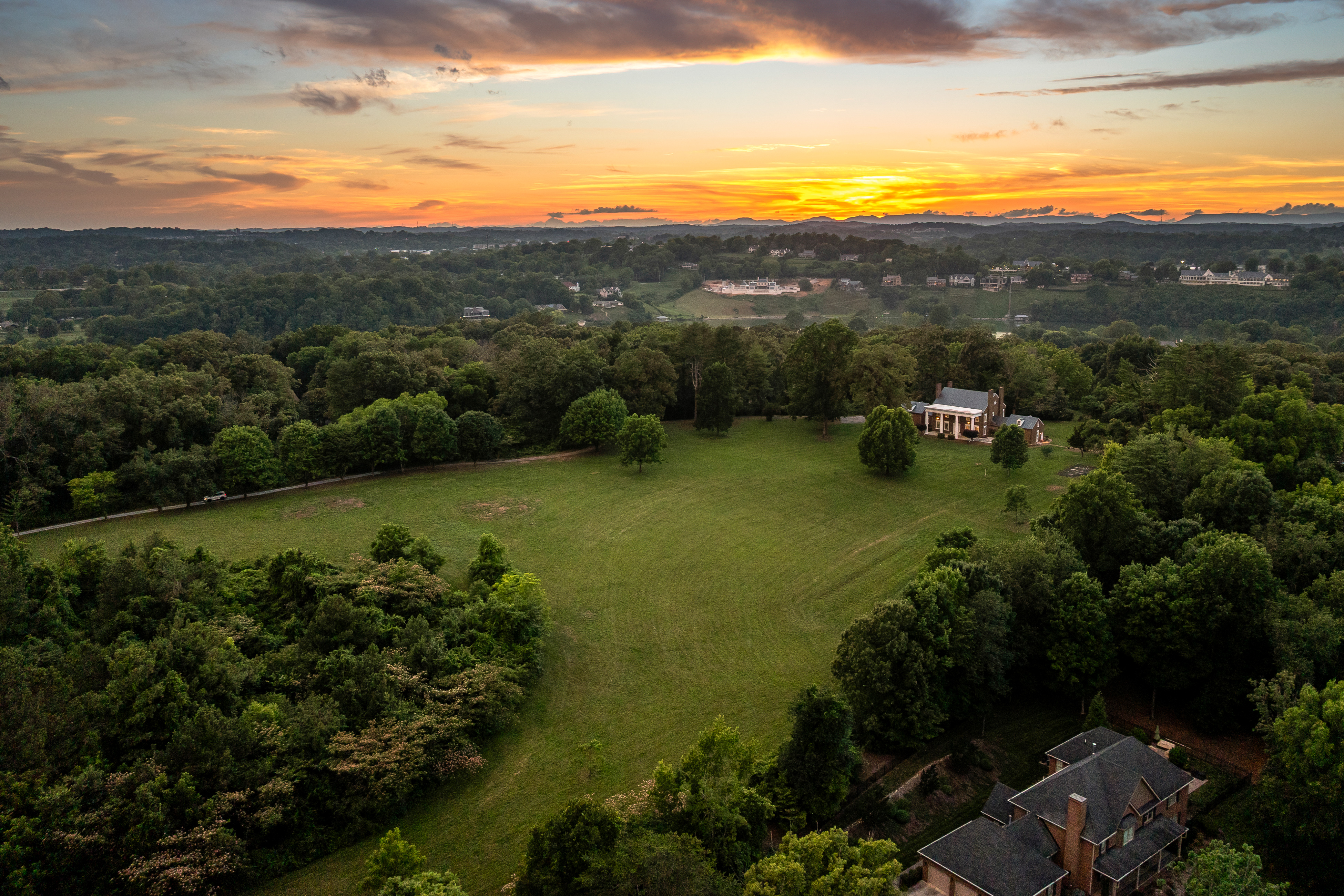 Aerial twilight — the meadow descending toward the valley