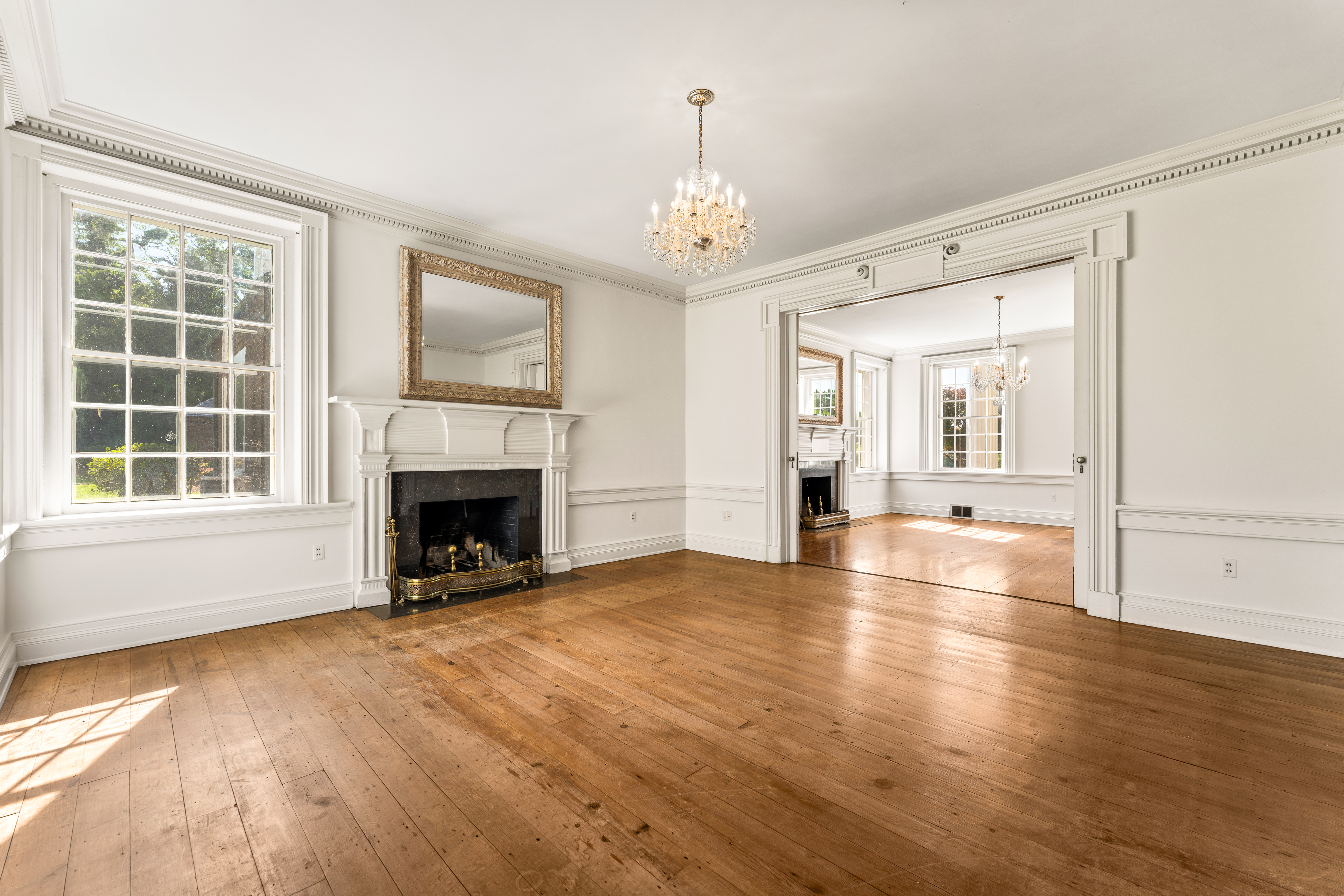 A reception room with hearth and river-view windows