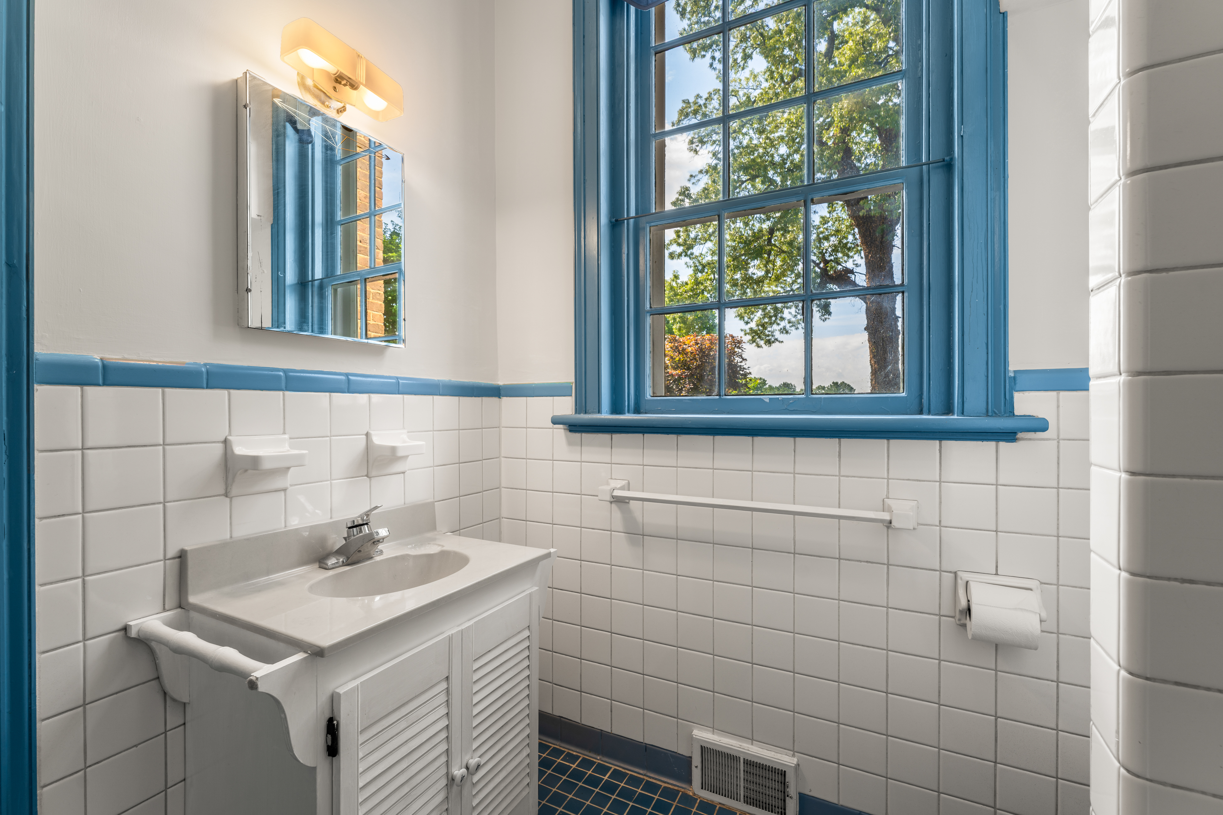 A period-blue bath adjoining the service passage