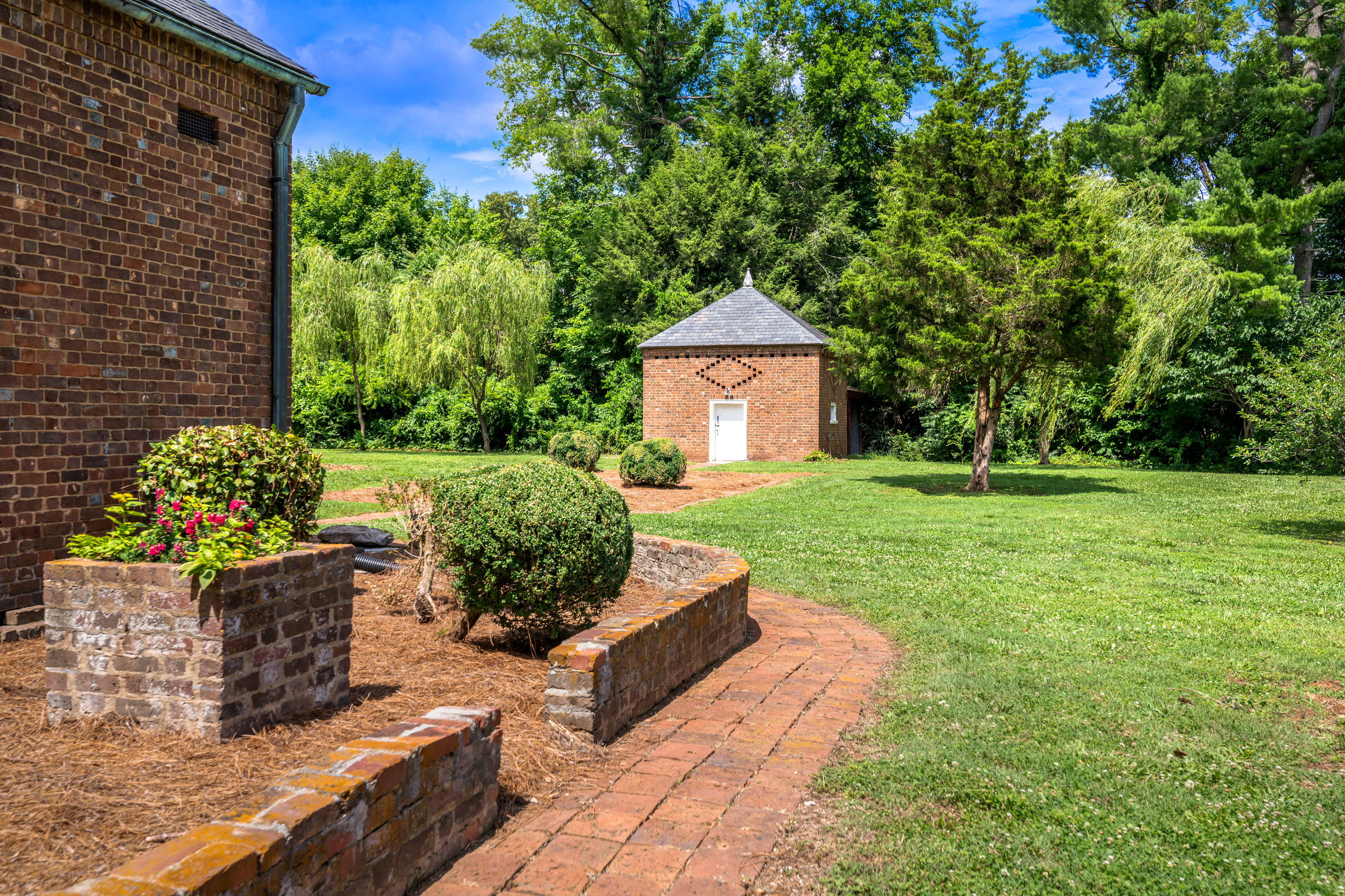 The historic brick smoke house from the east