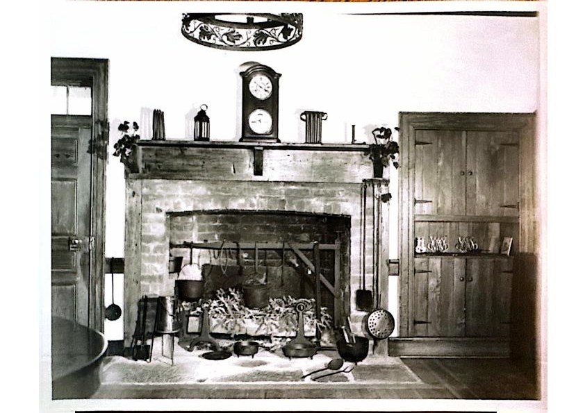 The Keeping Room hearth — mantel clock and iron ring