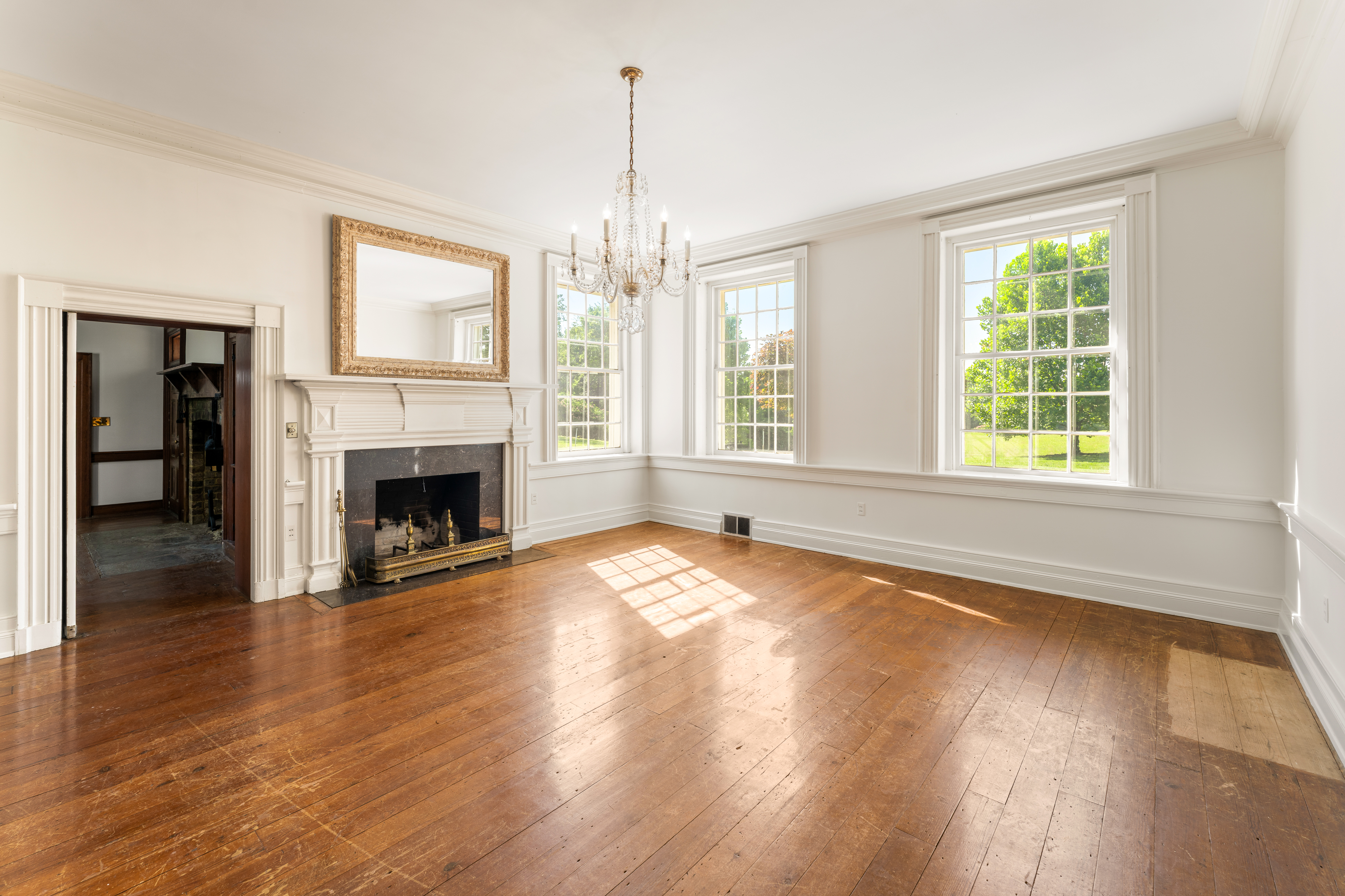 The formal drawing room, chandelier and hearth