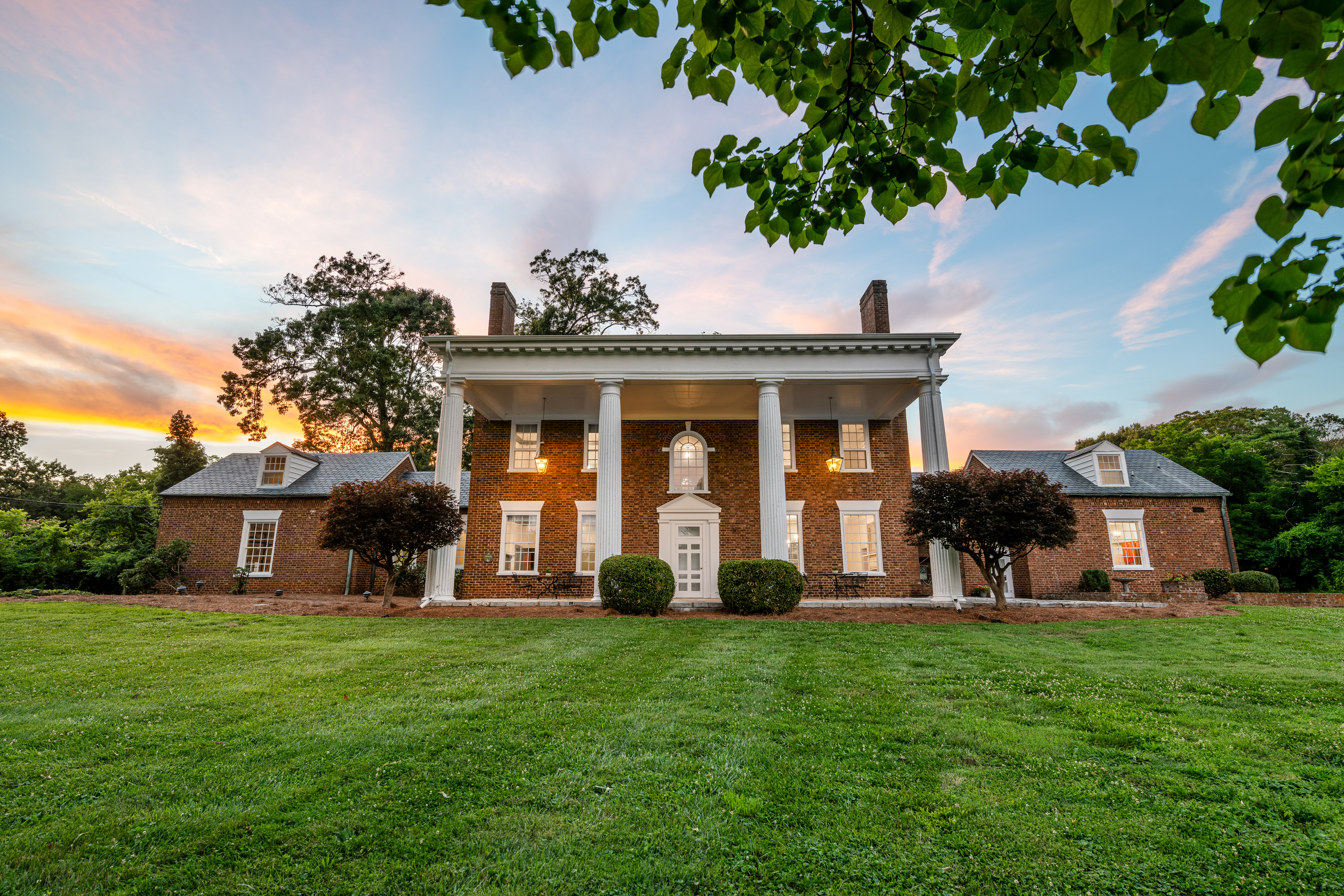 The Georgian façade framed by mature trees