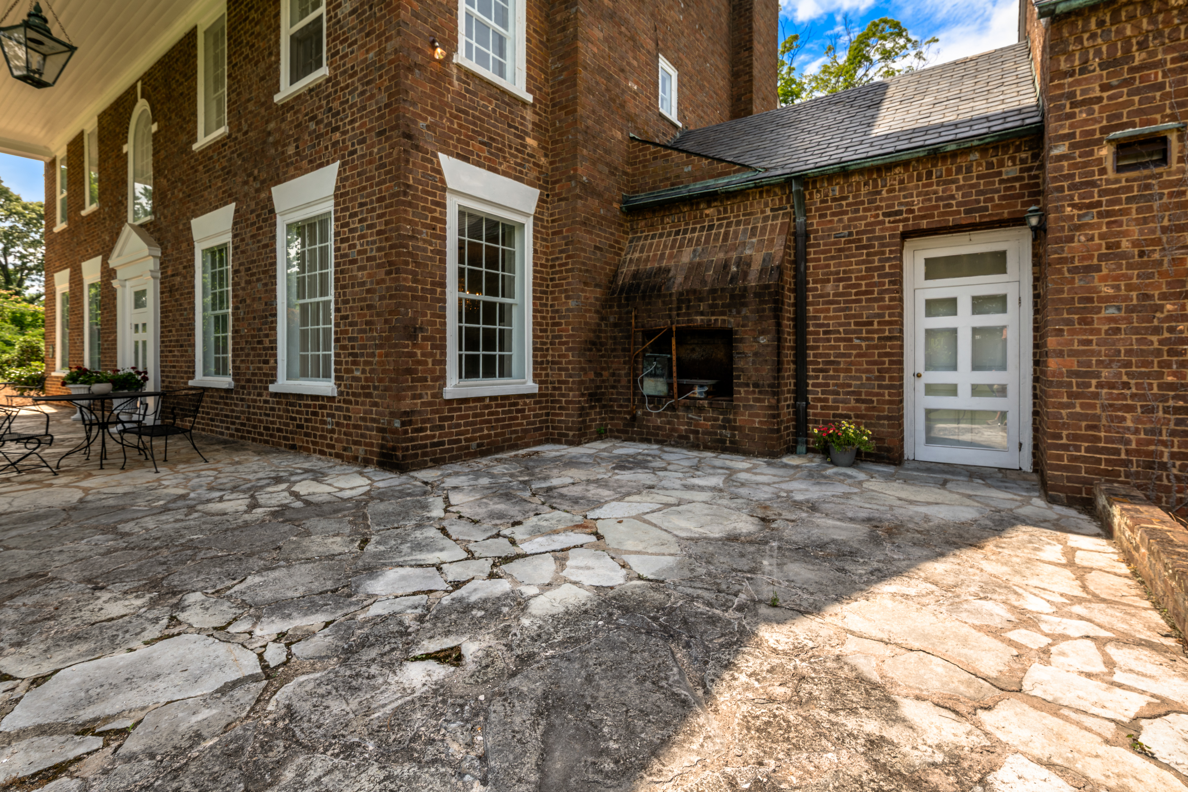 The rear terrace — flagstone paving beneath the porch