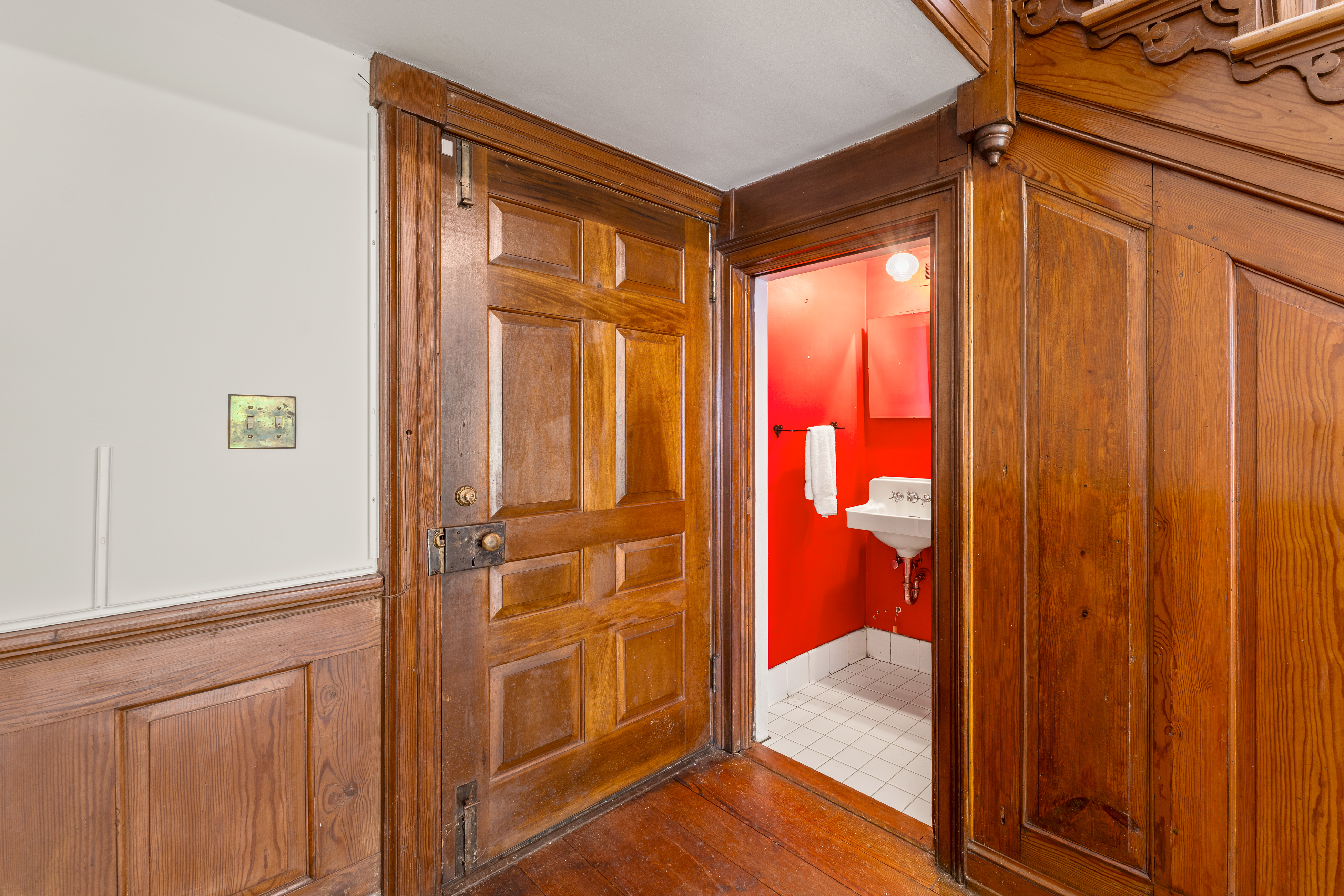 The paneled powder-room vestibule