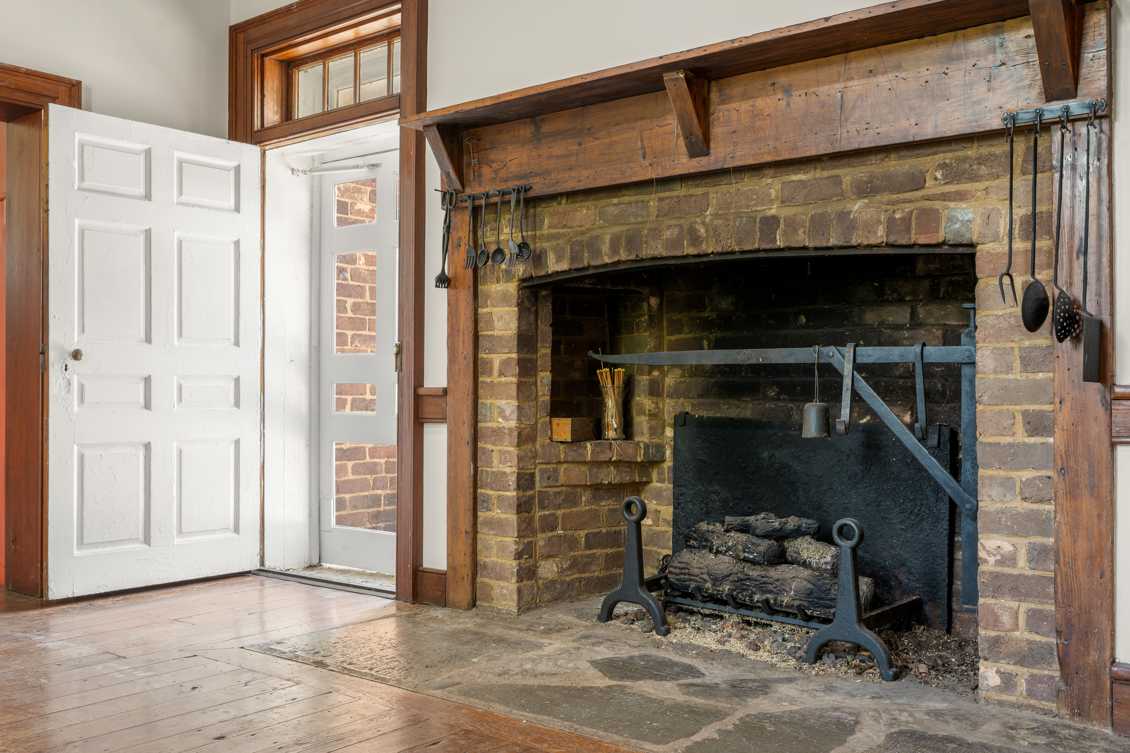 The keeping-room hearth with wrought-iron cranes