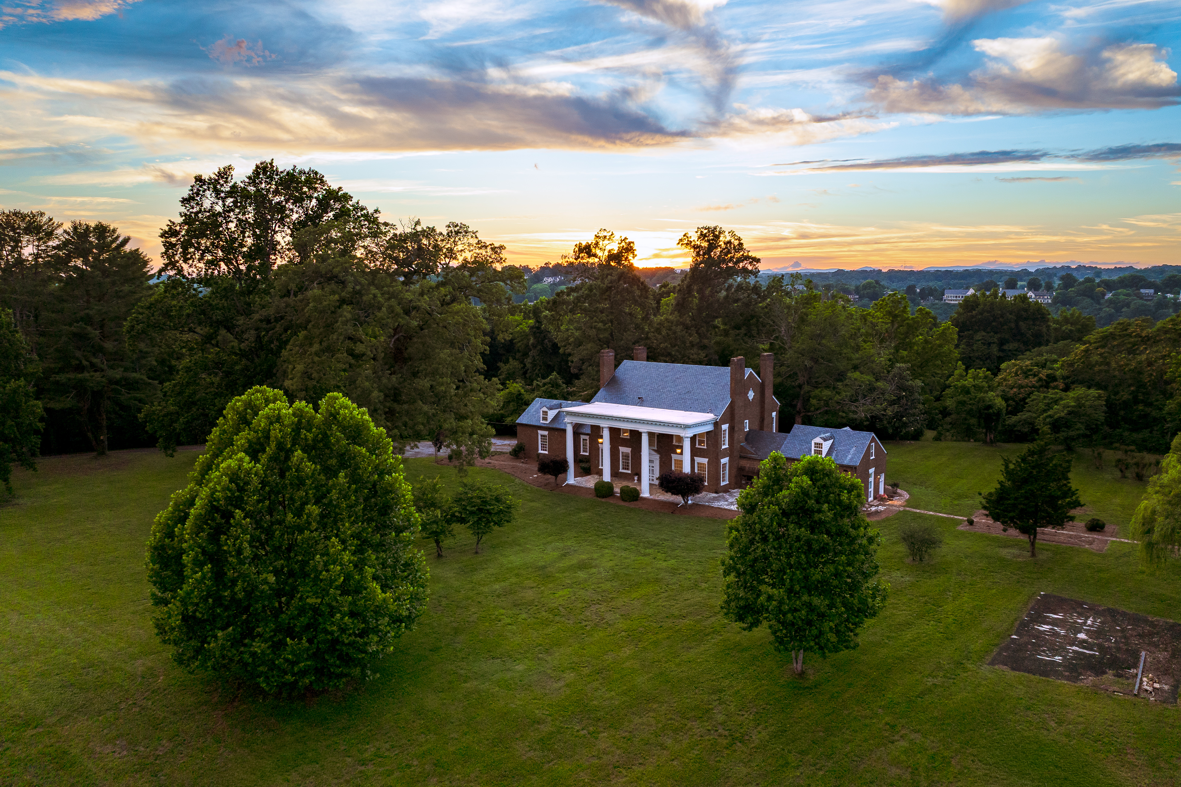 Aerial: the manor set within its wooded canopy