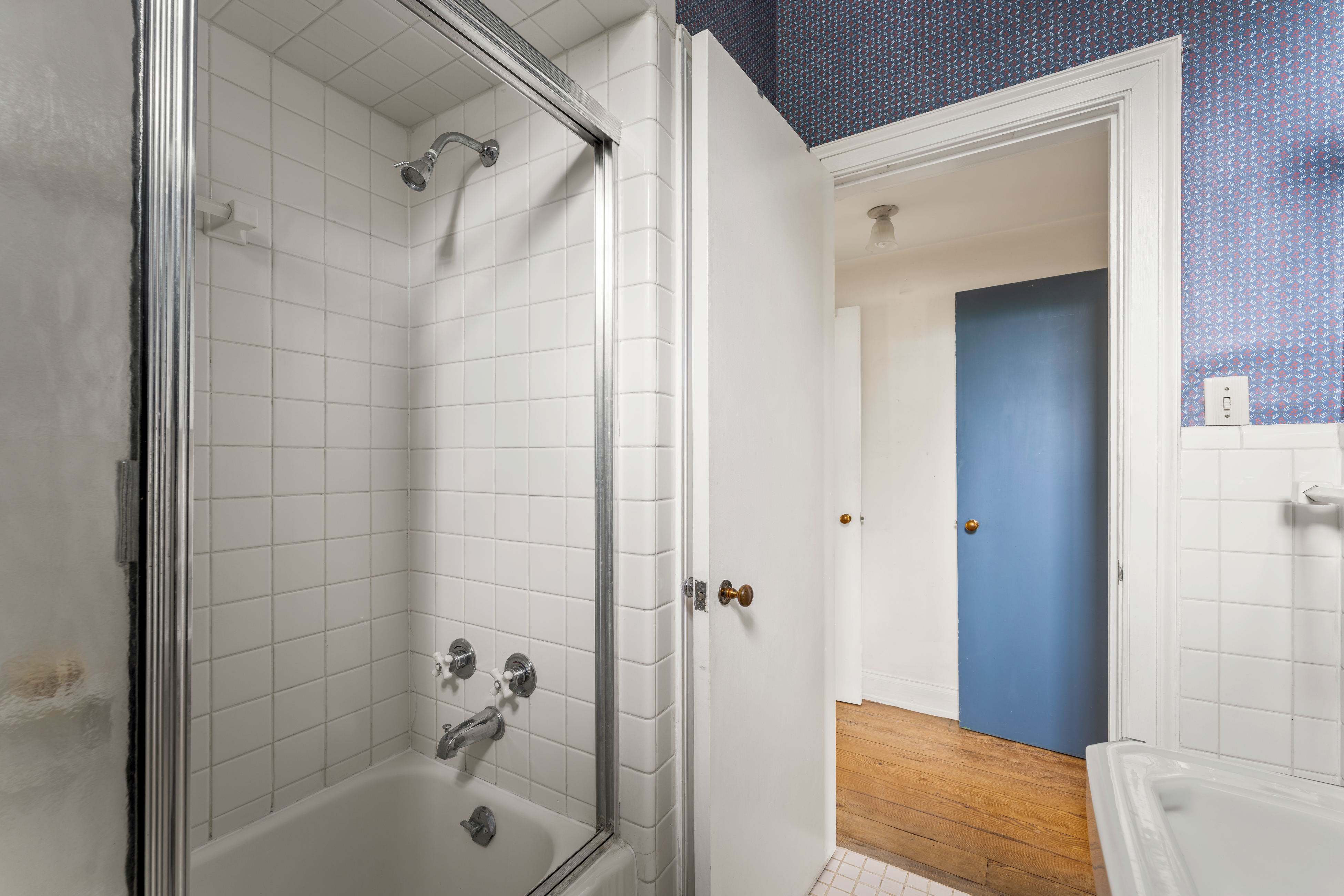 A secondary bath — wall-hung basin and sash window