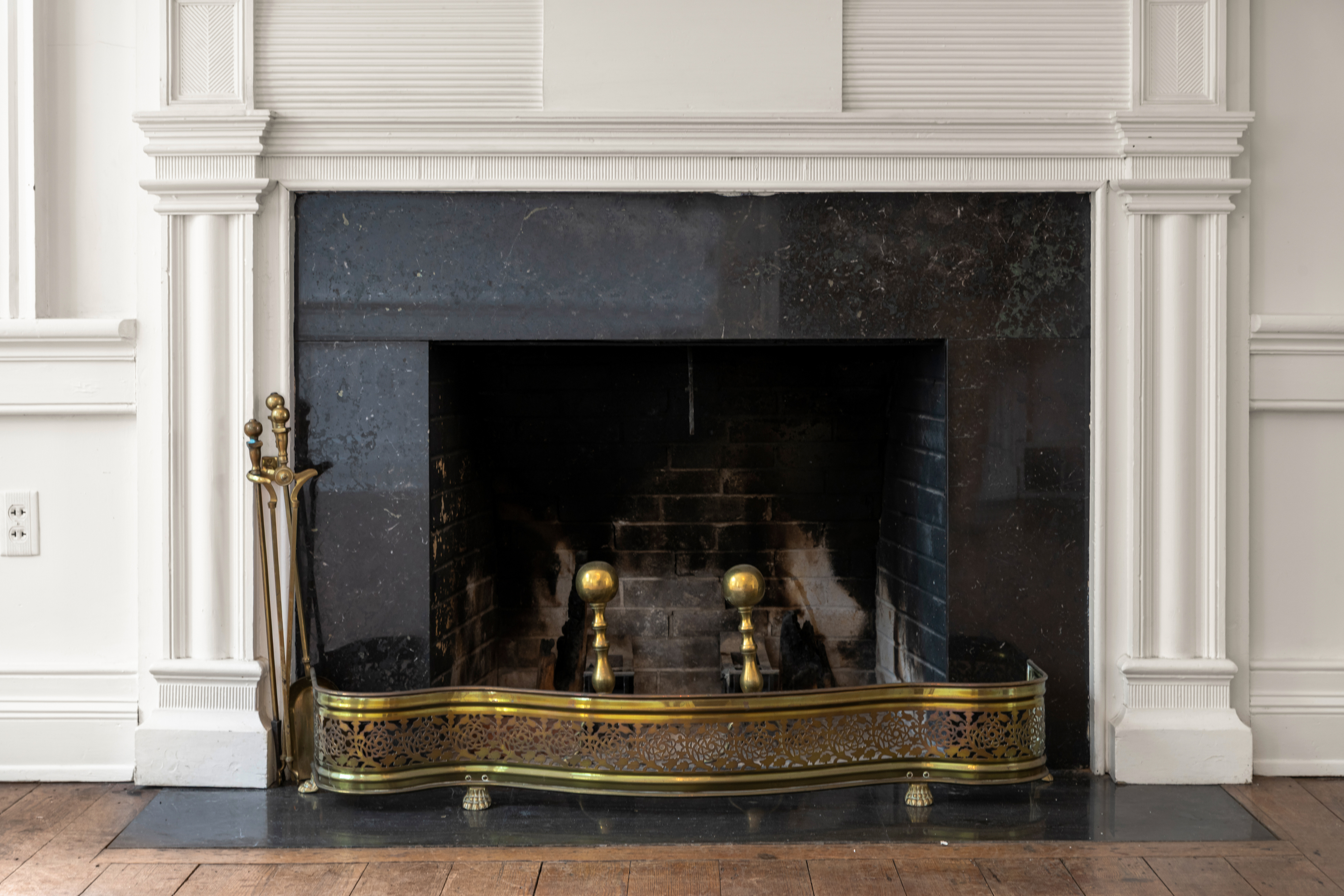 A working fireplace with polished brass andirons