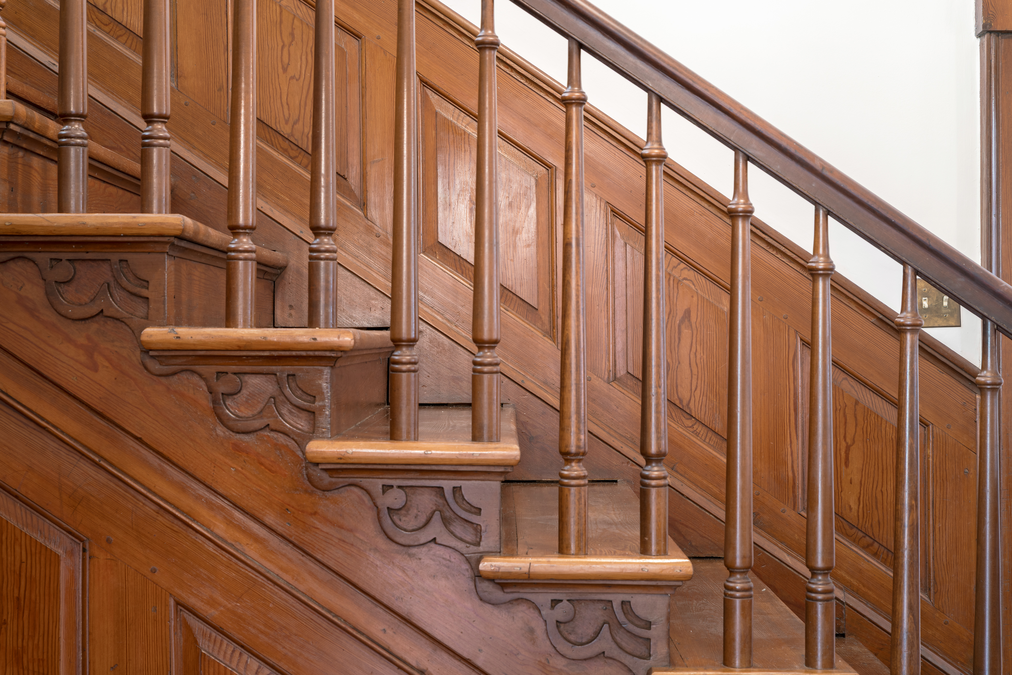 The original staircase — turned spindles and mahogany rail