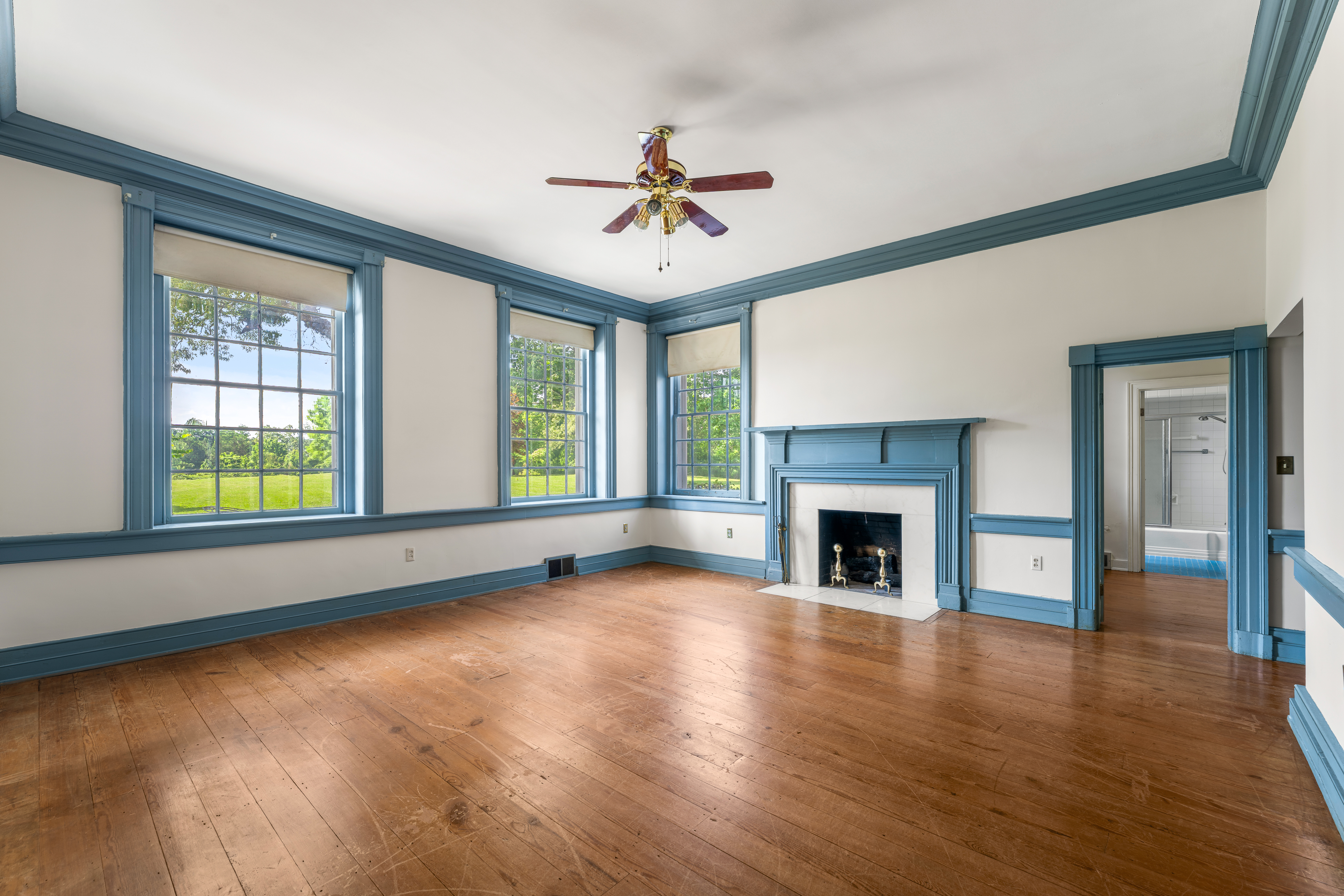 A Federal-blue trimmed chamber with paired chandeliers