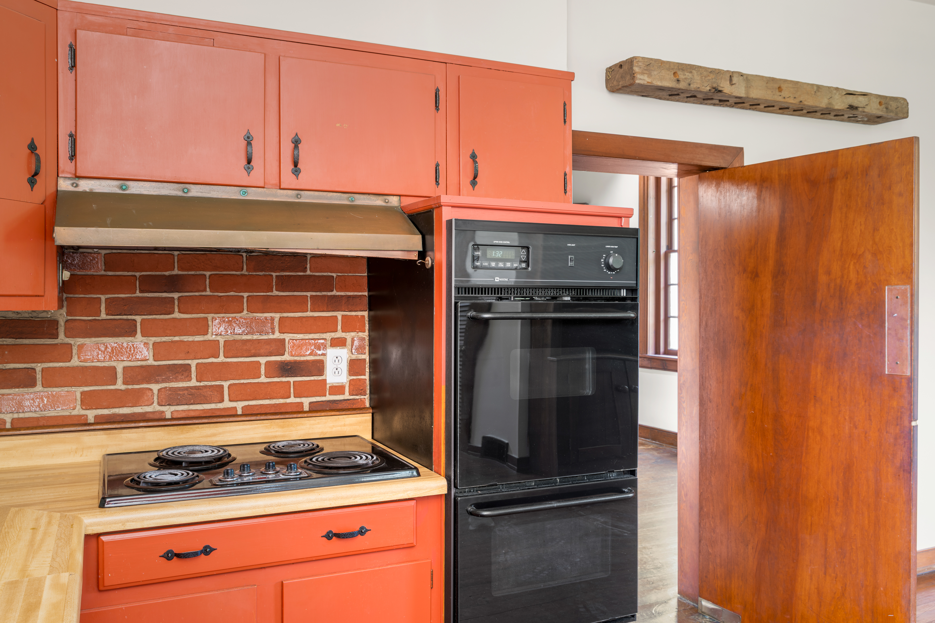Kitchen detail — brick backsplash and heart-pine mantel