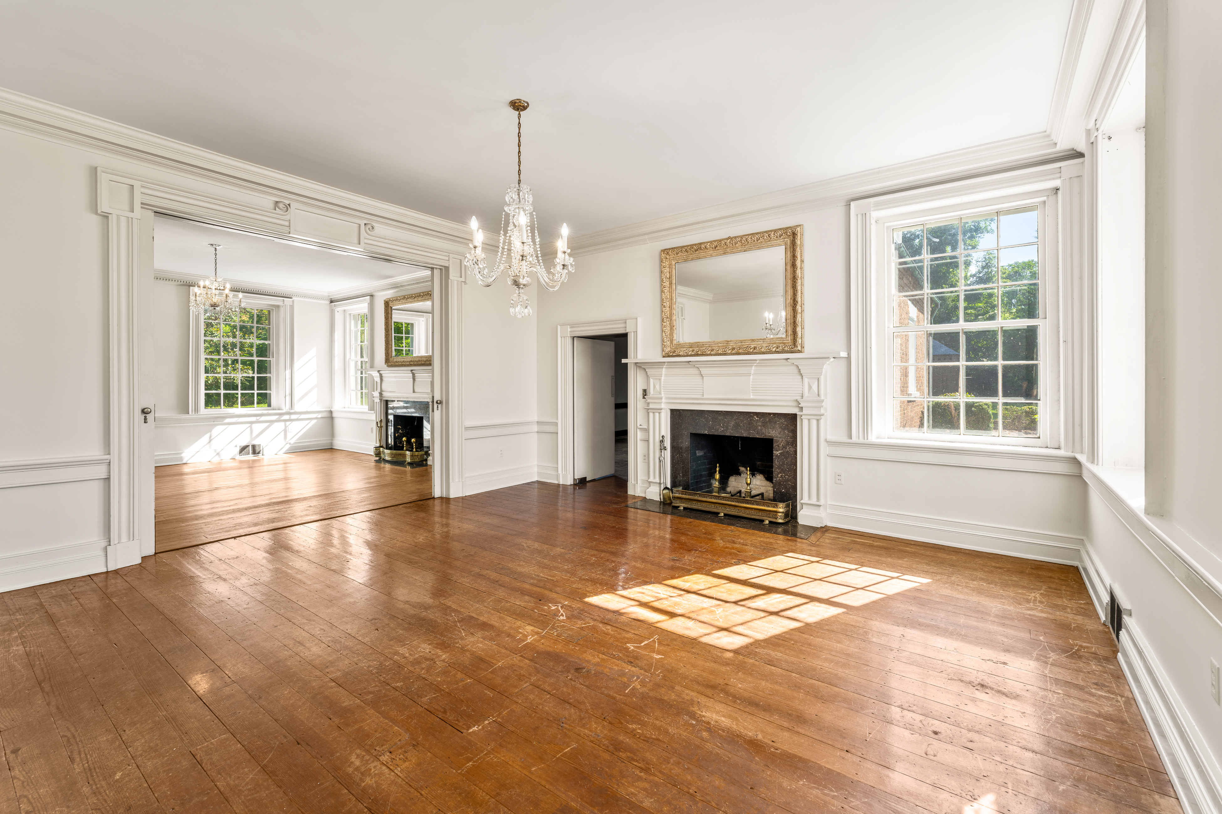 A reception room, crystal chandelier and hearth