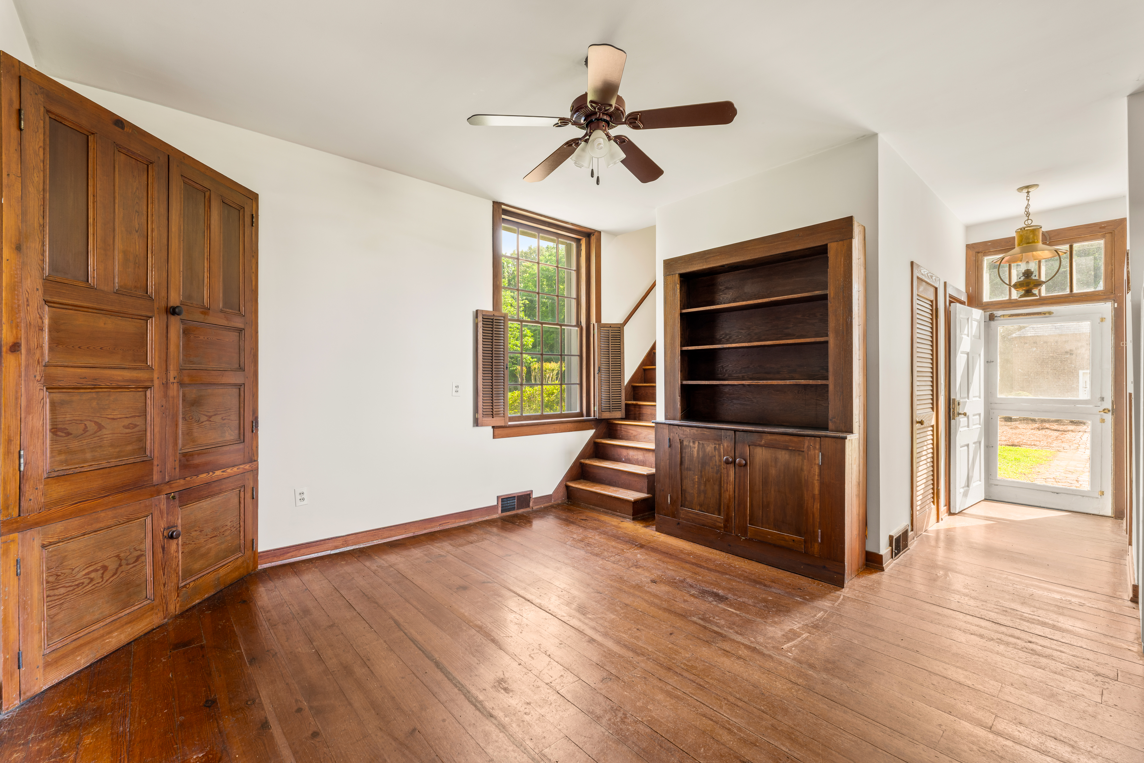 A service hall with secondary stair and paneled door